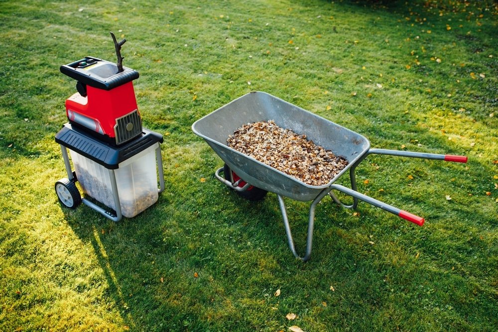 A wheelbarrow and an electric mulcher