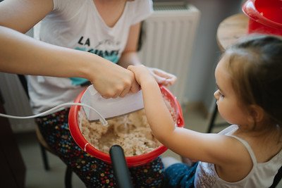 young girl helping her mother in the kitchen