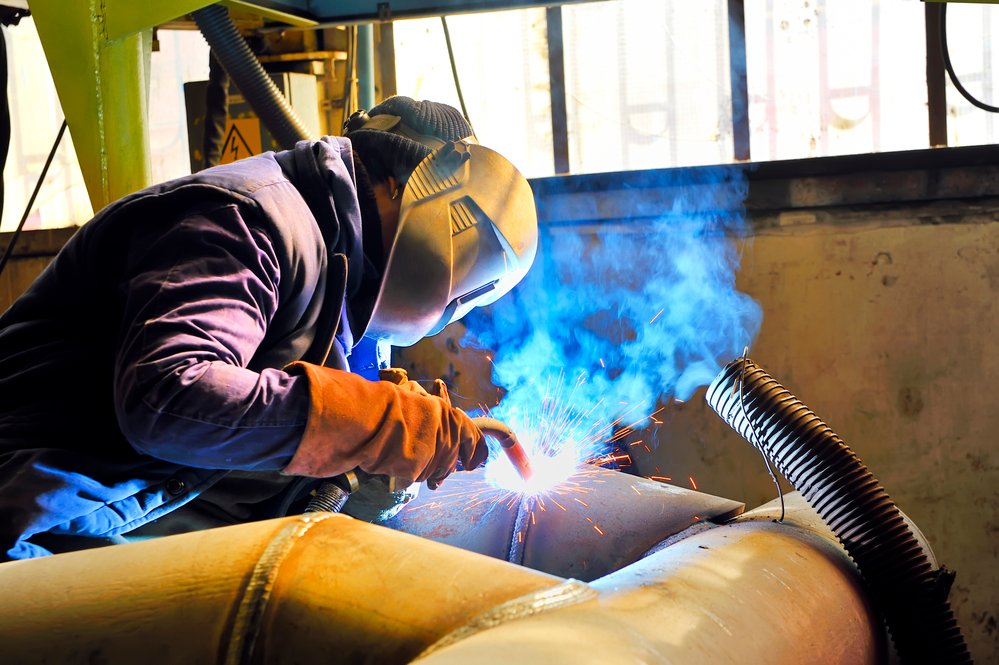 A man welds a big piece of metal
