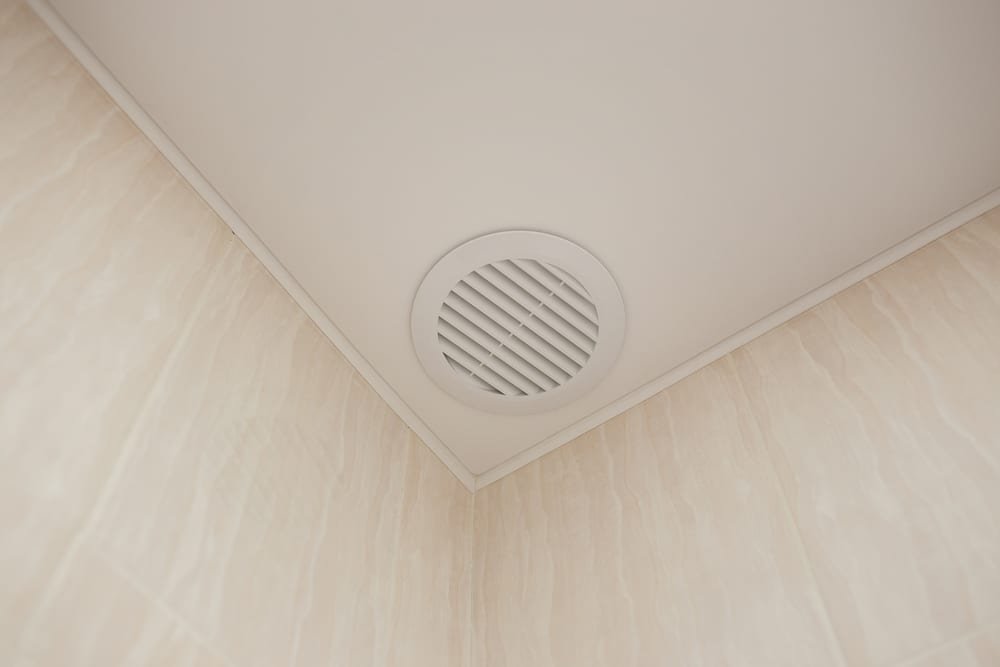 An electric exhaust system installed in a bathroom's ceiling.