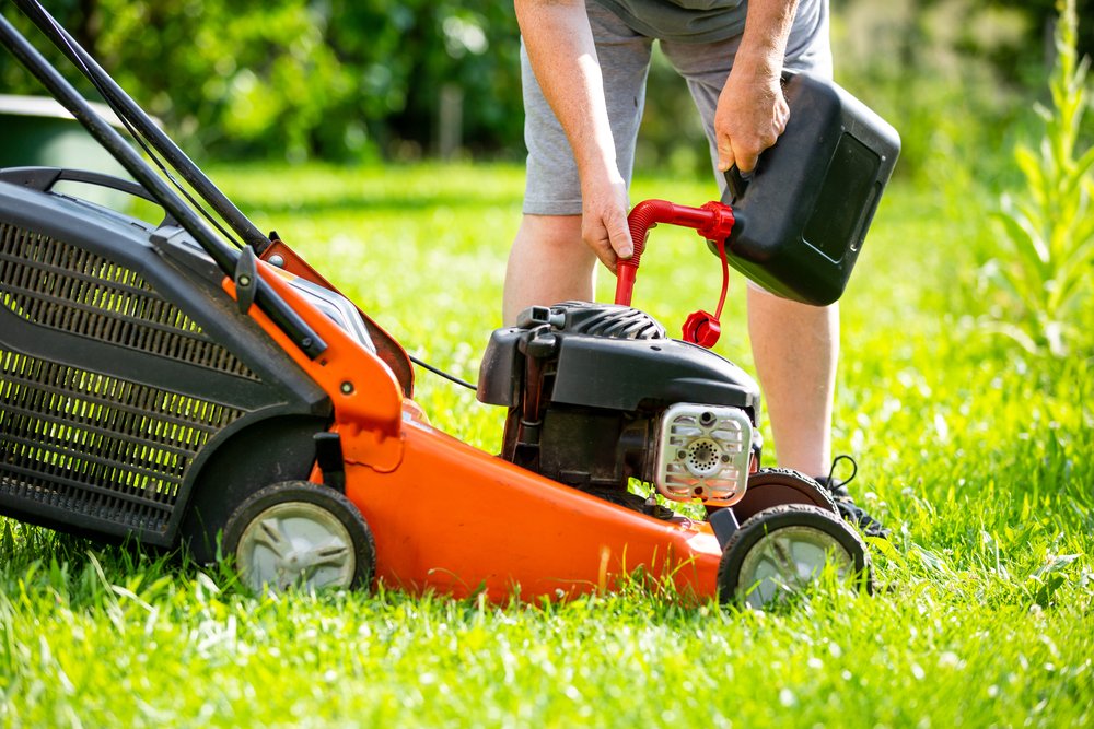 Man refueling his garden equipment