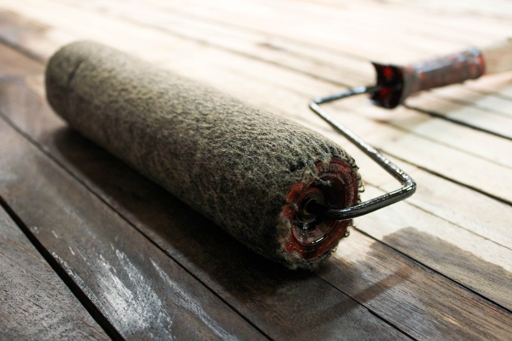 Staining a piece of timber with a roller