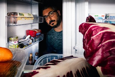 a man opening his refrigerator