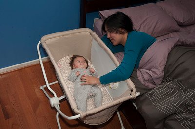a mother putting her baby to sleep