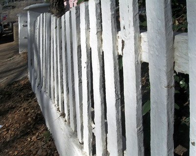 a-close-up-image-of-wooden-barriers-in-a-backyard