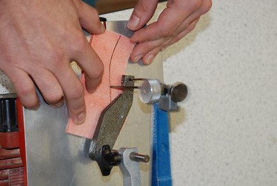 a-man-cutting-through-a-small-piece-of-wood